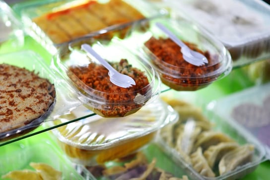 Food containers in convenience store deli shelf