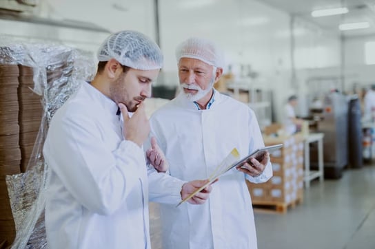 Food scientists looking over supply list in a food lab